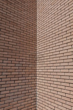 Red brick wall corner building masonry background. Architectural detail.