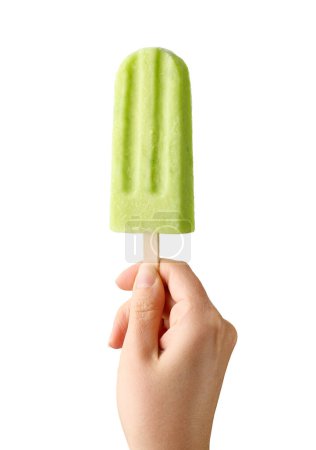Photo for Woman hand holding green fruit popsicle isolated on white background. Apple, lime and pear flavor - Royalty Free Image