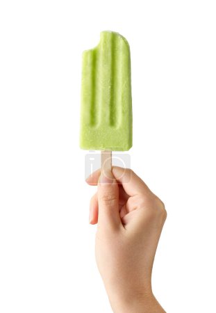 Photo for Woman hand holding bitten green fruit popsicle isolated on white background. Apple, lime and pear flavor - Royalty Free Image