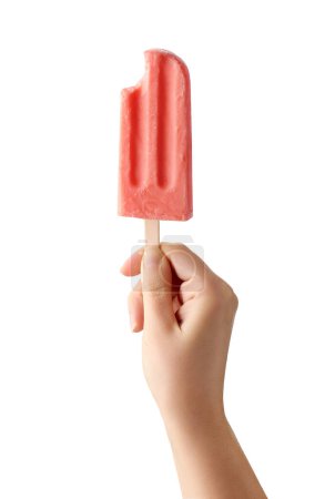Photo for Woman hand holding bitten pink fruit popsicle isolated on white background. Strawberry and watermelon flavor - Royalty Free Image