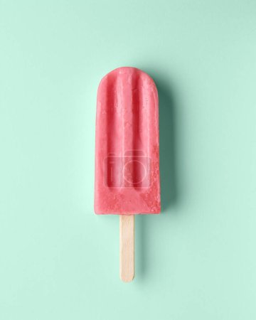 Photo for Pink fruit and berry popsicle on pastel mint background. Watermelon and strawberry flavor - Royalty Free Image
