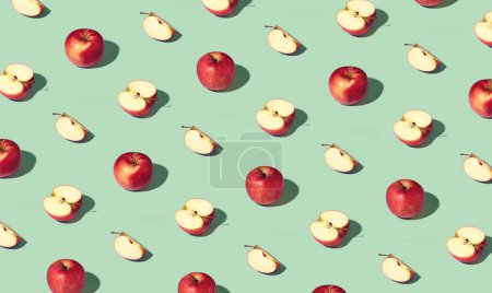 Photo for Colorful pattern of fresh ripe whole and sliced red apples. Minimal trendy sunlight fruit concept on light green background - Royalty Free Image