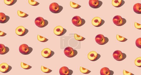 Photo for Colorful pattern of fresh ripe whole and sliced peaches. Minimal trendy sunlight fruit concept on light peach background - Royalty Free Image