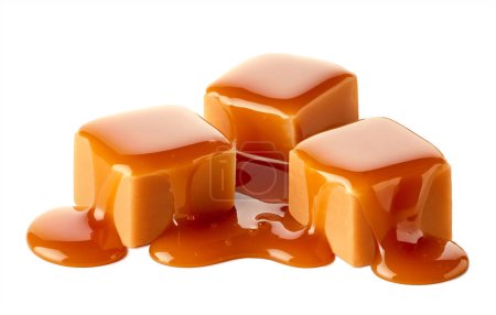 Téléchargez les photos : Trois cubes de bonbons au caramel sucré garnis de sauce au caramel isolé sur fond blanc - en image libre de droit