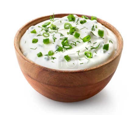 Photo for Wooden bowl of fresh sour cream dip sauce with herbs, green onions and dill isolated on white background - Royalty Free Image