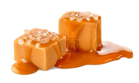 Photo for Two salty caramel candy cubes topped with caramel sauce and salt isolated on white background - Royalty Free Image
