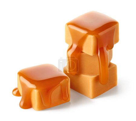 Photo for Stack of sweet caramel candy cubes topped with caramel sauce isolated on white background - Royalty Free Image