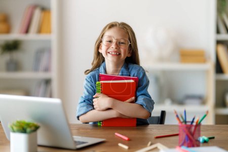 Photo for Back to school. Happy child is sitting at desk. Girl doing homework or online education. - Royalty Free Image