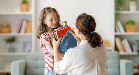 Photo for Happy family preparing for school. Little girl with mother. - Royalty Free Image