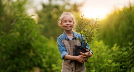 Photo for Happy child gardening in the backyard. Kid learning botany. - Royalty Free Image