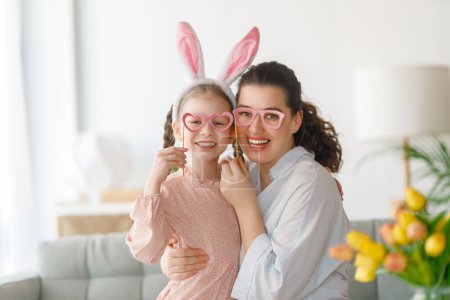 Photo for Happy holiday. Mother and her daughter. Family celebrating Easter. Cute little child girl is wearing bunny ears. - Royalty Free Image