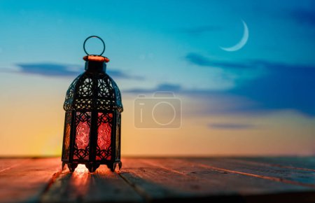 Photo for Ornamental Arabic lantern with burning candle glowing at night. Festive greeting card, invitation for Muslim holy month Ramadan Kareem. - Royalty Free Image