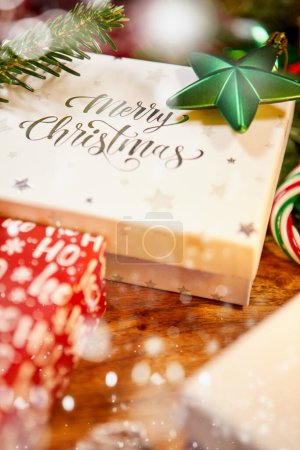 Photo for Christmas scene with a white gift box, red bow and ribbon, candles, lights, baubles, fir branches and snow, with copy space - Royalty Free Image