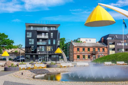 Photo for RAKVERE, ESTONIA - JUNE 17, 2022: View to central square with fountain and modern yellow lantern - Royalty Free Image
