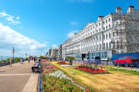 Photo for EASTBOURNE, ENGLAND - JULY 20, 2022: People walking along Eastbourne promenade - Royalty Free Image