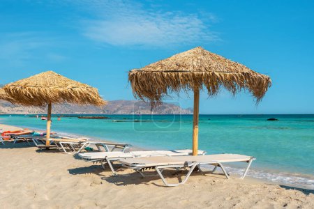 View to sun loungers and straw parasols on the Elafonissi beach. Crete, Greec