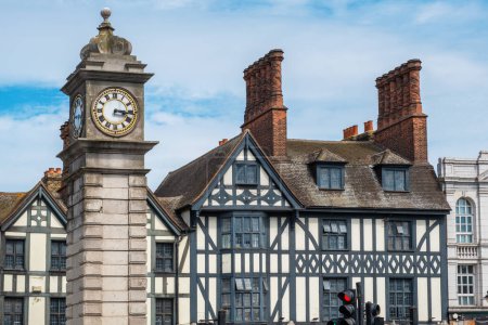 Photo for Victorian clock tower next to the half-timbered buildings in Clapham district. London, England - Royalty Free Image
