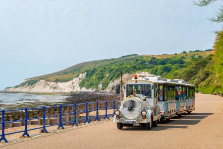 Photo for Eastbourne, England - July 21, 2022: Sightseeing tourist tour train is riding along seaside promenade - Royalty Free Image