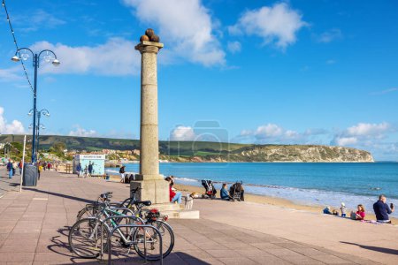Photo for Swanage, Dorset, England - October 14, 2023: View looking down seaside promenade and King Alfred Memorial - Royalty Free Image