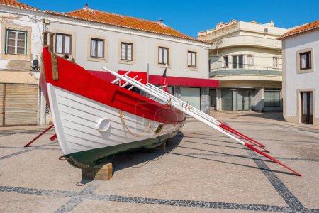 View to town square with traditional wooden boat in Peniche. Leiria, Portugal