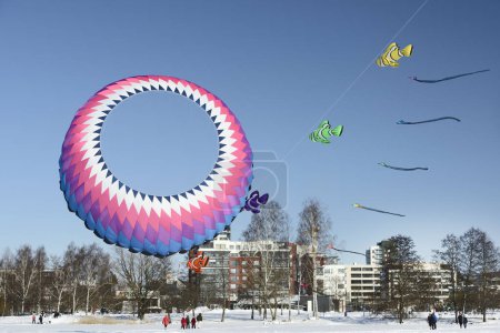Photo for Kites over Tuusula lake in Jarvenpaa on a sunny winter day February 26, 2023 - Royalty Free Image