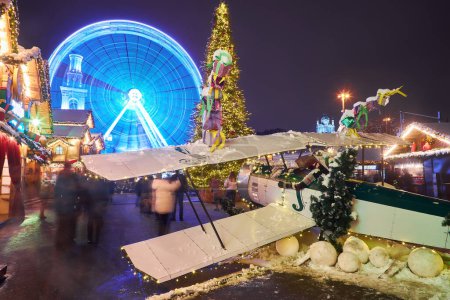 Photo for Christmas market with New Year Tree in Kyiv, Ukraine. The Ferris wheel and Christmas decoration at the Kontraktova Square on Podil. - Royalty Free Image
