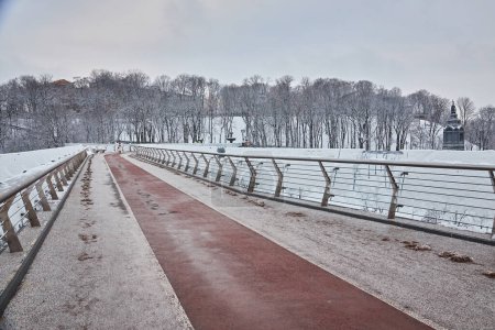 Photo for Pedestrian-bicycle bridge in Kiev in snowy weather. - Royalty Free Image