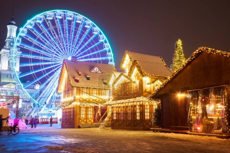 Photo for Christmas market with New Year Tree in Kyiv, Ukraine. The Ferris wheel and Christmas decoration at the Kontraktova Square on Podil. - Royalty Free Image