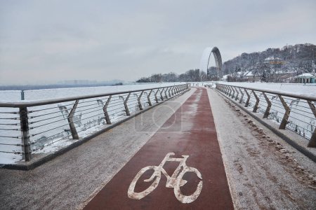 Photo for Pedestrian-bicycle bridge in Kiev in snowy weather. - Royalty Free Image