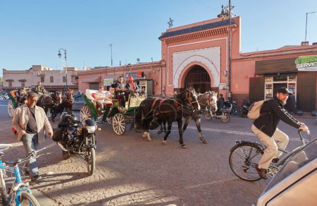 Téléchargez les photos : Morocco, Marrakech, February 02, 2017: Streets with traffic motorbikes driving in market district and people walking - en image libre de droit
