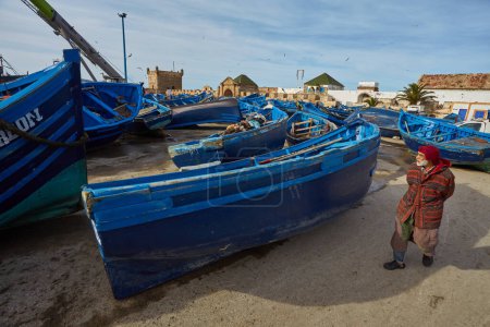 Téléchargez les photos : ESSAOUIRA, MOROCCO. 13 th February, 2017: Typical blue fishing boat on the coast of Essouira, Morocco. The city was called Sidi Megdoulin in 11th-century - en image libre de droit