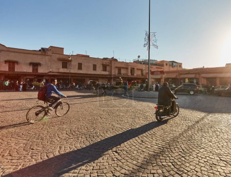 Photo for Morocco, Marrakech, February 02, 2017: Streets with traffic motorbike driving in market district and people walking - Royalty Free Image