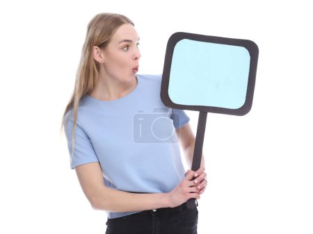 Foto de Emotional young woman showing empty signboard with copy space isolated on white - Imagen libre de derechos