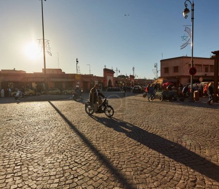 Photo for Morocco, Marrakech, February 02, 2017: Streets with traffic motorbikes driving in market district and people walking - Royalty Free Image