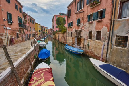 Photo for Beautiful narrow canal with silky water in Venice, Italy - Royalty Free Image
