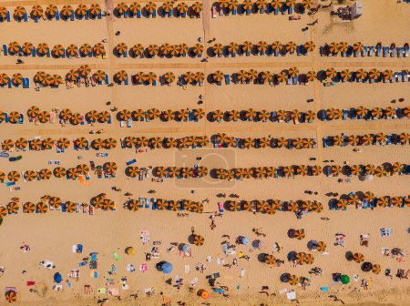 Foto de Aerial drone photo of famous organised with sun beds and umbrellas beach of Lia with emerald clear sandy sea shore, Mykonos island, Cyclades, Greece - Imagen libre de derechos