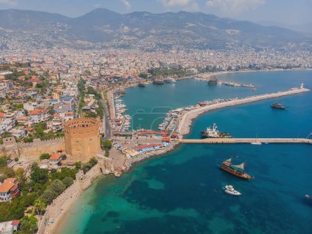 Téléchargez les photos : Kizil Kule or Red Tower and port aerial panoramic view in Alanya city, Antalya Province on the southern coast of Turkey. Summer photo taken from a drone - en image libre de droit