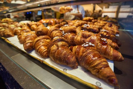 Photo for Close up view - assortment of freshly baked croissants for sale on counter of shop, market, cafe or bakery. Dessert, pastry, breakfast, sweet food and traditional french cuisine concept - Royalty Free Image