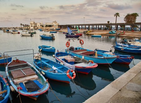 Bari town skyline and fishing boats - harbor in Apulia region, Italy.