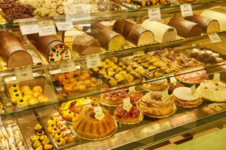 Photo for Naples, Italy - October 25, 2019: Neapolitan pastry shop with the counter full of delicious typical sweets such as sfogliatella, bab , zeppola and others, for sale in the streets of the city. - Royalty Free Image