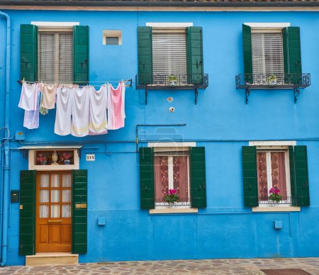 Photo for Blue facade of the house with door and windows. Colorful architecture in Burano, Italy. - Royalty Free Image