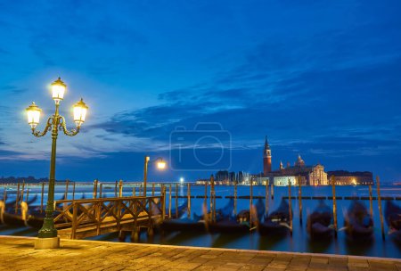 Photo for Gondolas at the St. Marks square in Venice, Italy, before a dramatic sunrise - Royalty Free Image