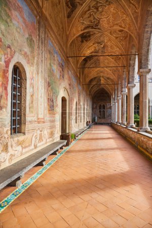 Photo for Naples, Italy - October 25, 2019: View of the decorated by frescoes cloister arcades of The Monumental Complex of Saint Claire in Naples, Italy. - Royalty Free Image