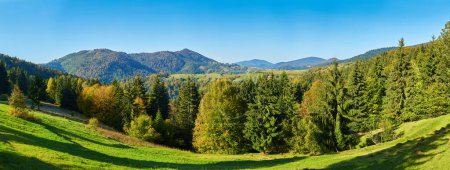 Photo for Behold the mesmerizing tapestry of autumn in the Carpathian Mountains. Majestic peaks stand proudly, surrounded by a vibrant kaleidoscope of foliage. Shades of red, orange, and gold paint the landscape, creating a breathtaking symphony of colors. - Royalty Free Image