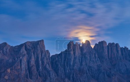 Photo for Night photo of Mount Latemar, the moon rises over the mountain range of Bolzano province, South tyrol, Italy - Royalty Free Image