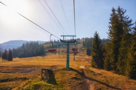 Photo for Old cable car nestled in the backdrop of picturesque autumn mountains, basking in the warm glow of a sunny day. - Royalty Free Image