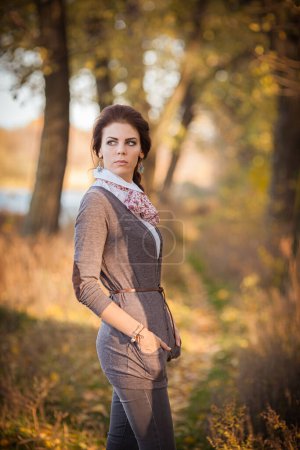 Photo for Brunette woman takes center stage amidst the enchanting colors of autumn. - Royalty Free Image