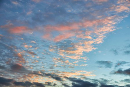 Photo for A breathtaking sunset scene with colorful hues painting the sky. Billowing clouds create a stunning backdrop, evoking a sense of tranquility and wonder, natural background - Royalty Free Image