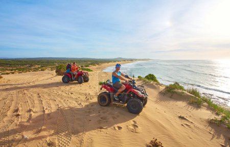 Photo for A group of tourists enjoys quad biking along Essaouira's oceanfront, creating an adventurous spectacle against the scenic coastal backdrop - Royalty Free Image
