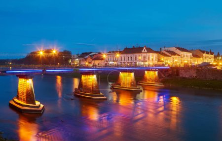 Illuminated pedestrian bridge in the center of Uzhgorod in the evening,